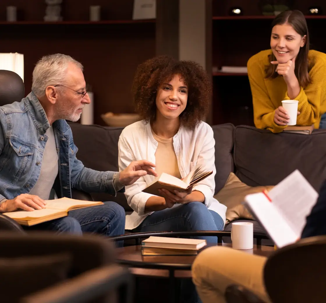 Group of people discussing a book in a cozy libraryr