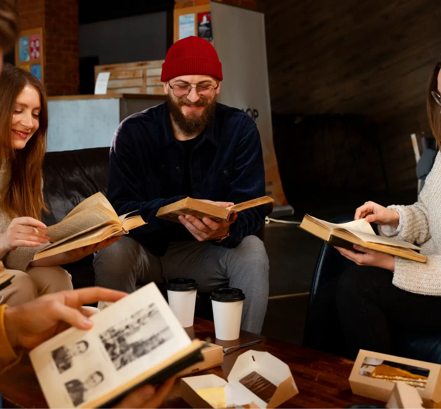 People reading books around a coffee table